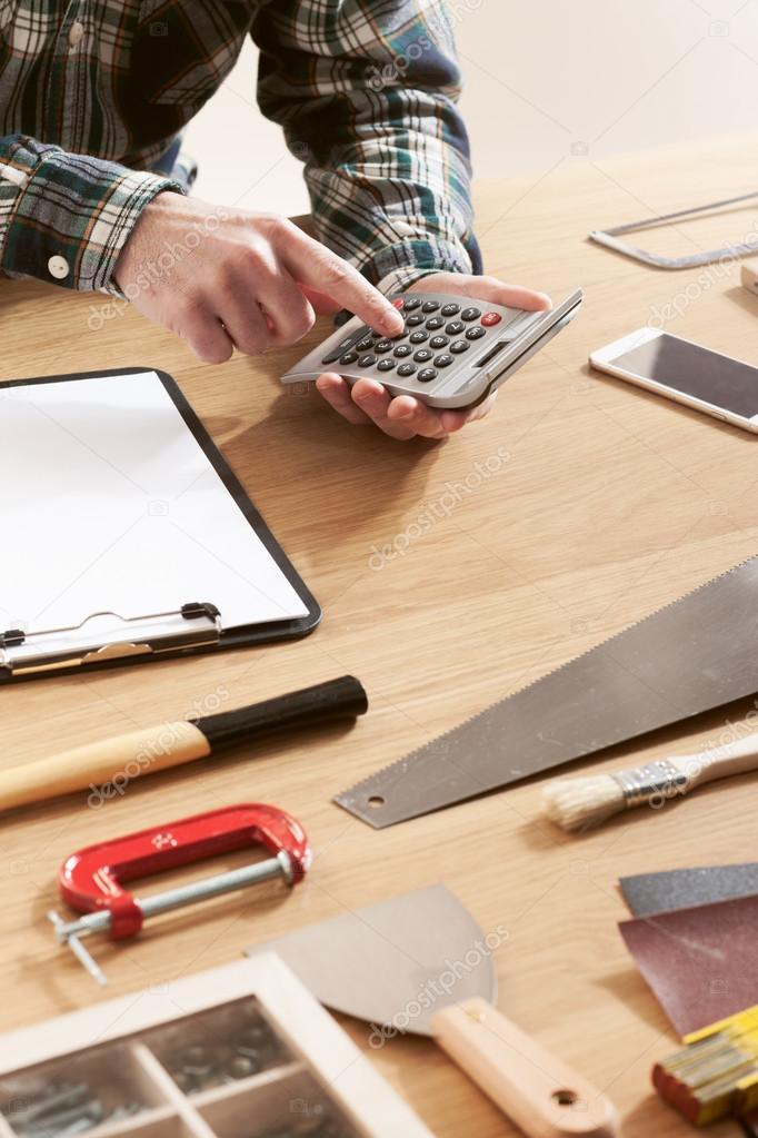 Handyman reviewing a quote with a homeowner at a kitchen table