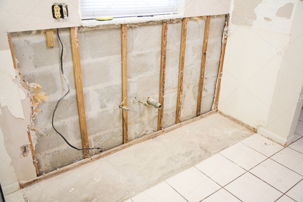 Damaged drywall with holes and cracks before repair