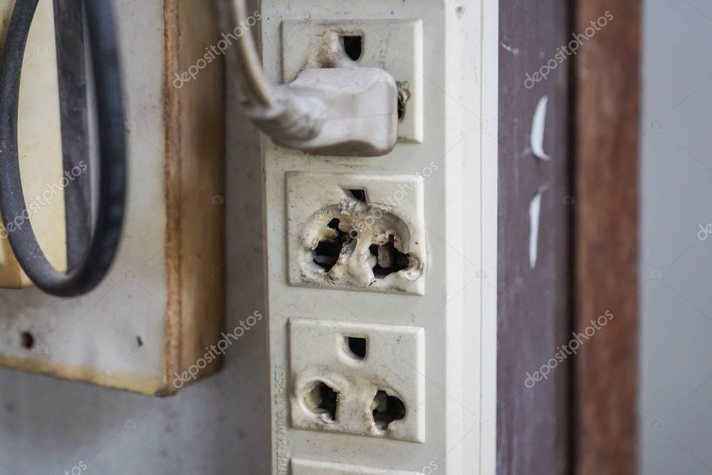 Loose electrical outlet hanging from box before fixing